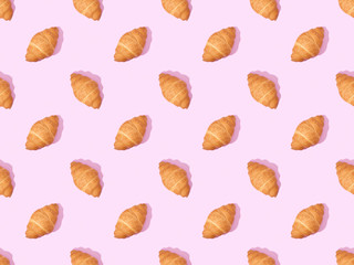 top view of croissants on pink, seamless background pattern