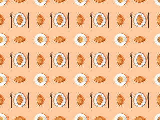 top view of cutlery, fresh croissants on plates and coffee on orange, seamless background pattern