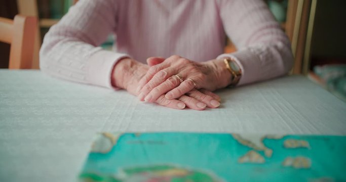 Old lady placing placing her hands  forward in a close-up view.