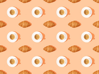top view of fresh croissants on plates and coffee on orange, seamless background pattern