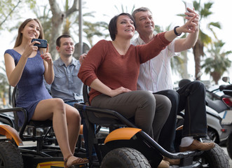 family of tourists enjoy a walk on the bike carriage