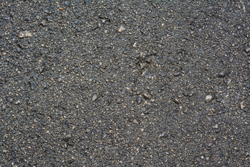 Detail of the texture of a wet road. Asphalt. Horizontal format.