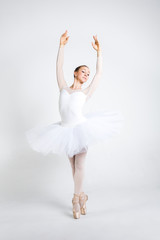 Fototapeta na wymiar Young ballerina practising ballet moves