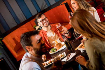 Young people having dinner in the restaurant