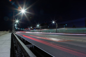 Fototapeta na wymiar Car trails at night on the road towards Sydney Harbour Bridge.