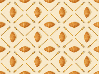 top view of golden forks and croissants on beige, seamless background pattern