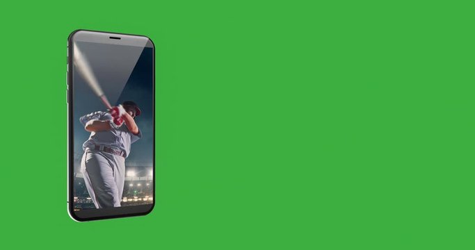 A mobile phone with baseball moment on the screen. A phone is over green background.
