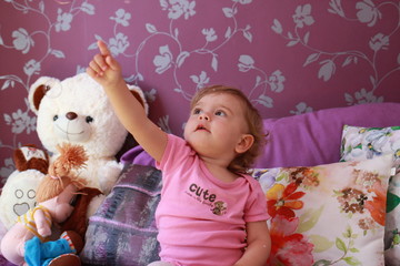 little cute caucasian girl plays in her room with soap bubbles. Children's emotions, smile and laughter. Close-up.