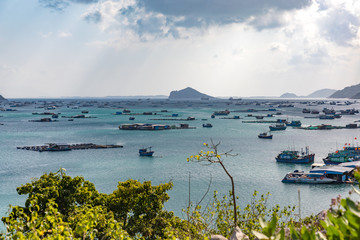 Fishing boats and freight ships in a bay in Vietnam