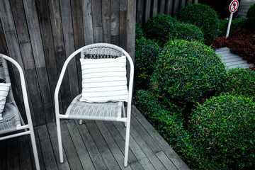 An outdoor seat with a small nearby garden