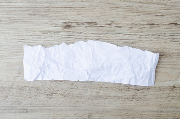 Obraz premium white crumpled paper texture on wood background, white paper on table background.