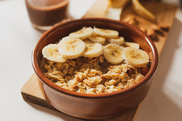 Oatmeal porridge with banana and almonds, healthy and nutrititious breakfast. 