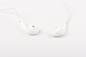 White headphones for listening to music and sound on portable devices: music player, smartphone, laptop and jack for connection on a white background.