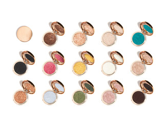 Different colours of eye shadow compact cosmetic make up at 45 degree angle isolated on white background with harsh shadows