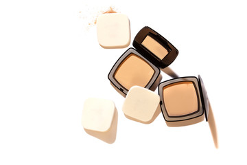 Face loose makeup powder. Real cosmetic powder in the black square glossy plastic case cover Isolated on white background and harsh shadows. Top view with applying foam