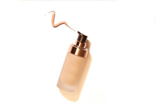 Container bottles for foundation or bb and cc cream.  Transparent glass bottle with dispenser. Template of packaging for cosmetic product with liquid pouring out