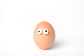 Natural egg with doodle eyes on white background