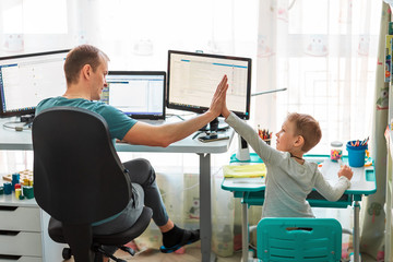 Father with kid working from home during quarantine. Stay at home, work from home concept during...