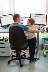Father with kid working from home during quarantine. Stay at home, work from home concept during...