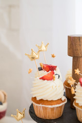 Assorted fruit cakes for holiday.Delicious cupcake with berries on table close up.mini tarts with fresh strawberries.Copy space