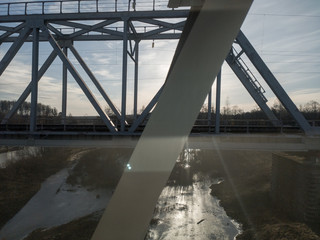 view from the train window on the nature of the Urals. blue sky snow and sun through the trees.