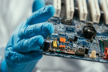 close up view of computer motherboard in hands on engineer