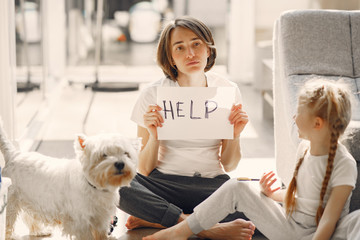 Coronavirus theme. Mother with daughter. Family stay at home. Mother needs help.