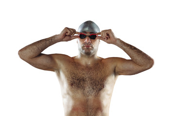 Professional caucasian male swimmer with hat and goggles practicing and training isolated on white studio background. Grace of motion and action. Healthy lifestyle, sport and movement concept.