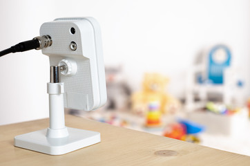 Security camera on Wood table. CCTV , ip camera Security monitoring playing room for kids