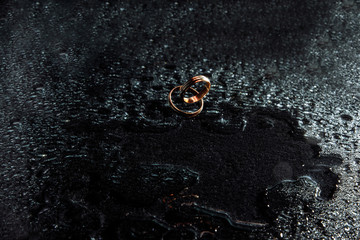 golden wedding rings in the rain