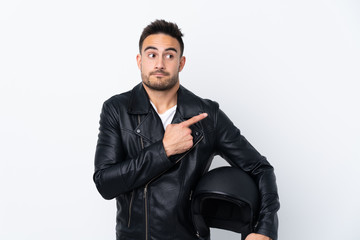 Man with a motorcycle helmet pointing to the laterals having doubts