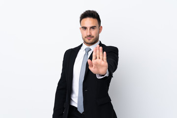 Young business man over isolated background making stop gesture with her hand