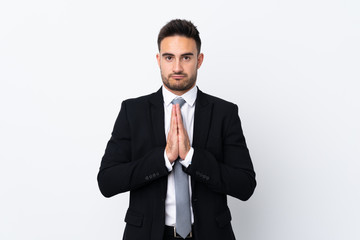 Young business man over isolated background pleading