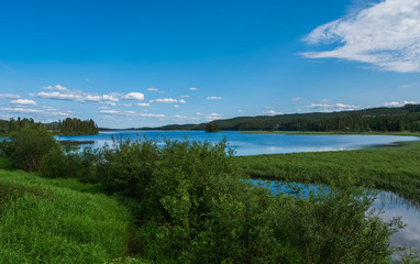 Small island on the Storan- sterdal lven lake in Idre, Sweden. Drone shot, july 2019