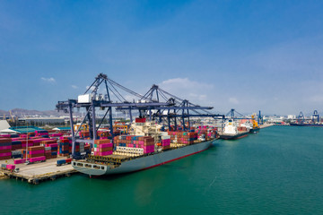 Naklejka premium shipping port and shipping containers with crane