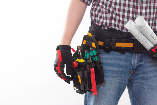Electrician or professional Builder in an installer's belt with tools on a white background. Electrician's tools in black bags on the worker's belt. Banner with space for text