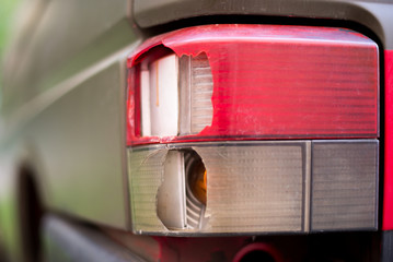 Broken headlight and front part of the bus after a traffic accident. Close-up.