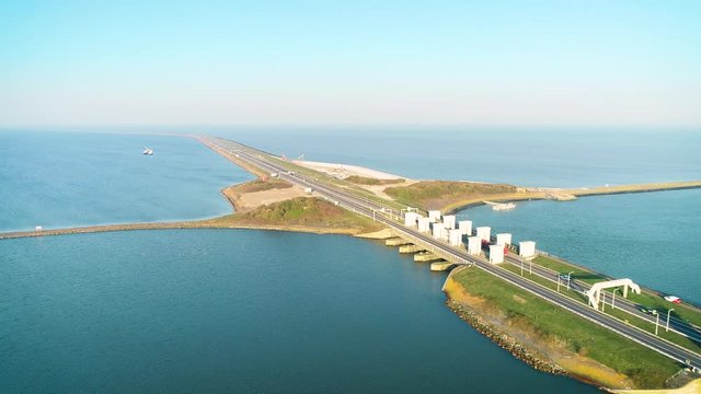 Enclosure Dam (Afsluitdijk): Trucks and Cars Driving on the Long Road of the Dam, Tracking Shot - Friesland, Netherlands / Holland &ndash; 4K Drone Footage