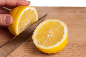 Lemon on cutting board isolated on white background.Copy space