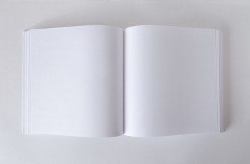 Mockup of an empty open book in square format. Template for design.