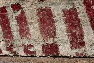 red stripes painted on the concrete as a warning and an indication of the size and limits as background or texture