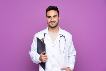 Young man wearing a doctor gown and holding a folder