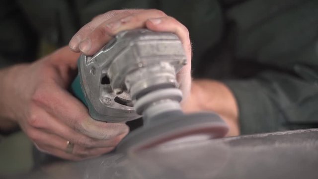  Worker in a green jacket polishes a marble table in a factory. Super Slow Motion