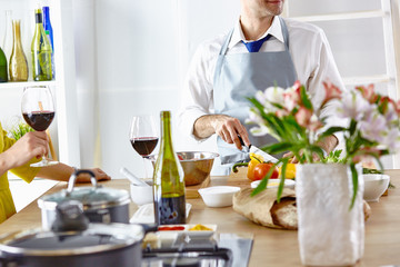 Smiling young couple cooking food in the kitchen