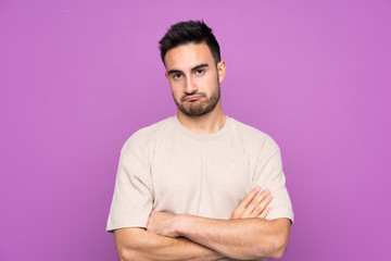 Obraz premium Young handsome man over isolated purple background feeling upset
