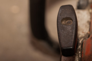 Old chainsaw in workshop. Defective chainsaw on service