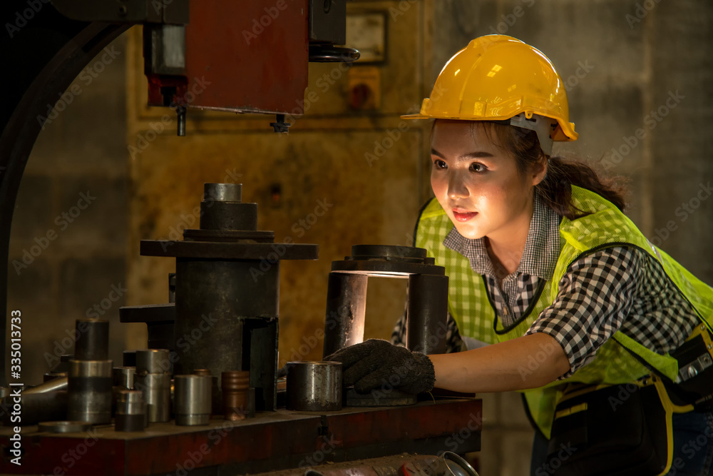 Poster female mechanic are working on machines in a factory,engineer checking equipment in the industrial.