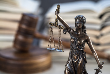 Law and Justice Symbols with law books on background. Law concept image.