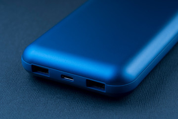 blue power Bank close- up on a blue trend background, selective focus, tinted image