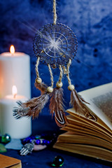 Dreamcatcher amulet feng shui. Dream catcher from metal and feathers against the background of...